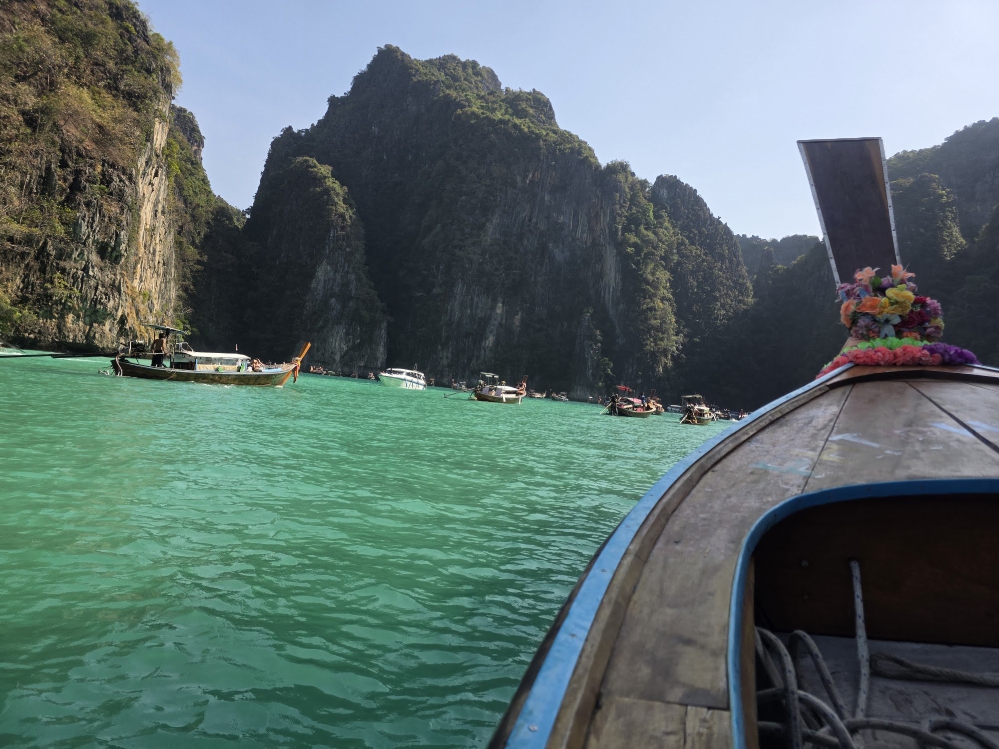 Limestone cliffs and turquoise water seen from a boat in Thailand